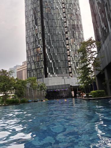 a swimming pool in front of a tall building at My Residence Villa Star Klcc in Kuala Lumpur