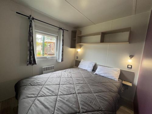 a bedroom with a large bed in a room at Un toit sur le bassin vue Foret in Lège-Cap-Ferret