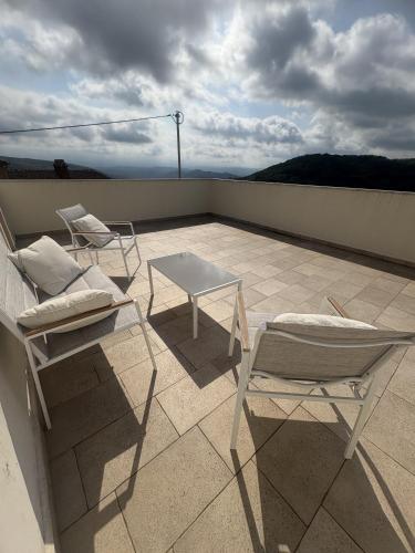 two chairs and a table on a roof at Villa Letizia in Oprtalj