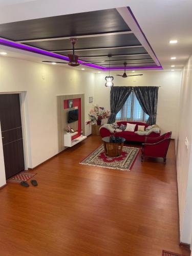a living room with purple lights on the ceiling at Castle villa in Ernakulam