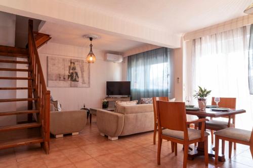 a living room with a couch and a table at Silot apartment 3 in Nea Fokea