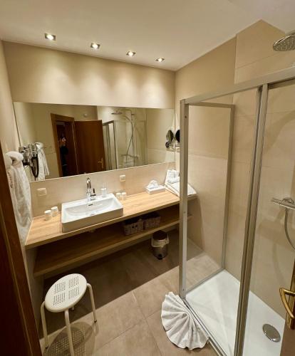 a bathroom with a sink and a shower at Appartements Oswaldeck in Bad Kleinkirchheim