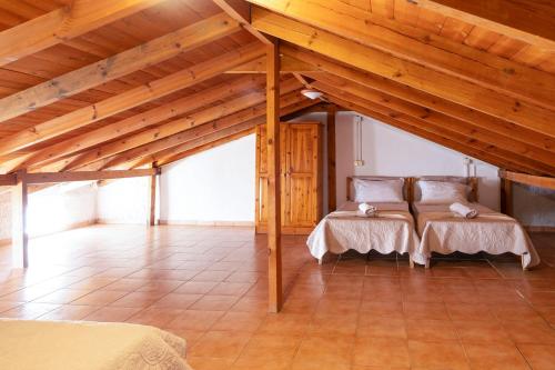 a large room with two beds in a attic at Silot apartment 3 in Nea Fokea