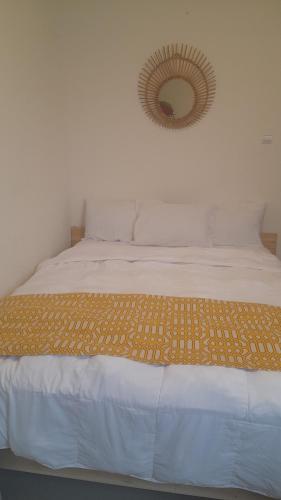 a bedroom with a bed with a mirror on the wall at Fatimah Pancar View in Cimandala