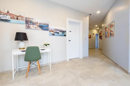 a room with a desk and a green chair at The Han YK Hotel in Avcılar