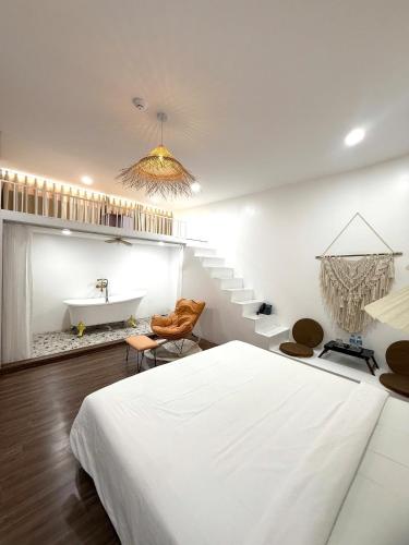 a bedroom with a bed and a bathroom with a sink at Pisces Hotel Hue in Hue
