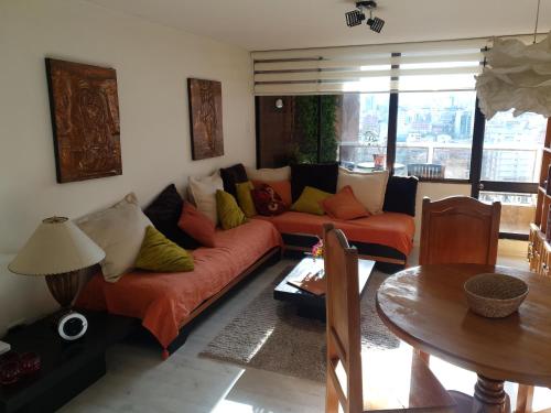 a living room with a couch and a table at French Suite Cordero in Quito