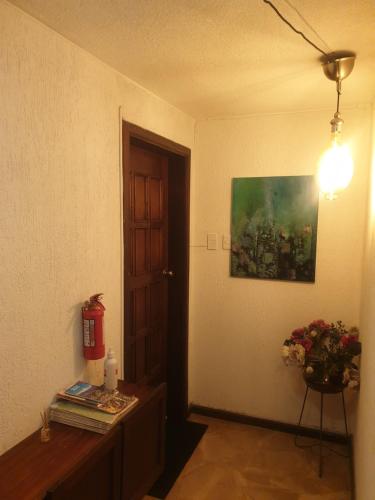a room with a table and a painting on the wall at French Suite Cordero in Quito