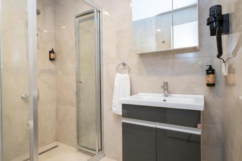 a bathroom with a sink and a shower at The Han YK Hotel in Avcılar