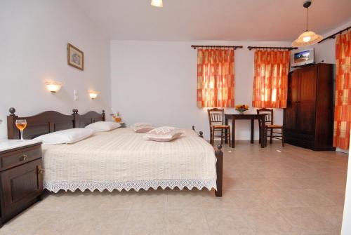 a bedroom with a large bed and a table at Sea Melody Studios in Plaka
