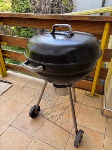 a charcoal grill sitting on top of a patio at House with Garden in Suwałki