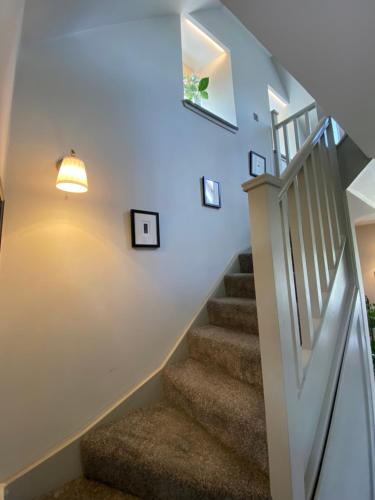 a staircase with a light fixture and a stair case at Cairn Leuchan in Ballater