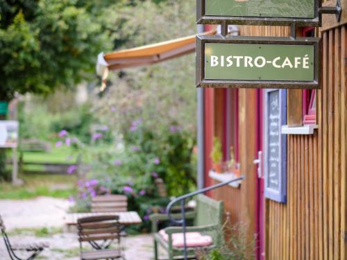 a sign for a bistro cafe on the side of a building at Biohof Medewege in Schwerin