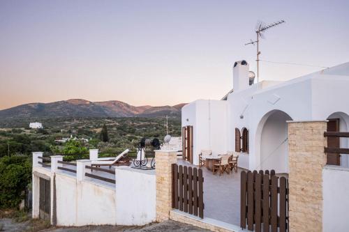 a white house with a view of the mountains at The Beach House Μουτσούνα Νάξος in Moutsouna Naxos
