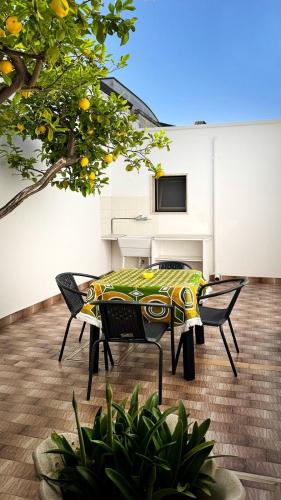 a table and chairs in a room with a television at Casa del Salento Il Limone in Trepuzzi