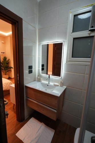 a bathroom with a sink and a mirror at Modern Studio No 3 By Diafa in Cairo