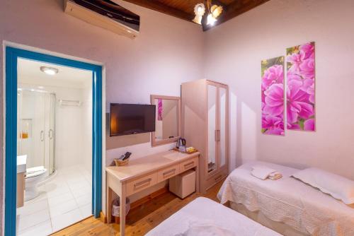 a bathroom with a sink and a desk with a mirror at Cypriot Swallow Boutique Hotel in North Nicosia