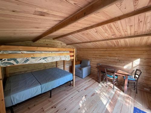 an overhead view of a bedroom with a bed and a table at M'Belles Cabanes in Viala-du-Tarn
