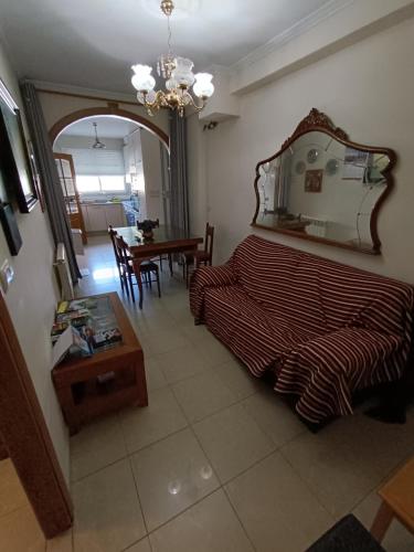 a bedroom with a bed and a table and a mirror at Albergue Ultreia Sigueiro in Sigüeiro