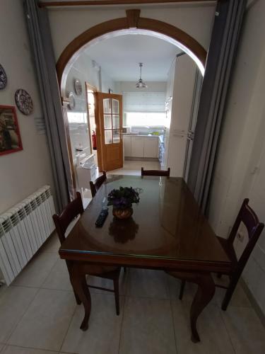 a dining room table and chairs in a room at Albergue Ultreia Sigueiro in Sigüeiro