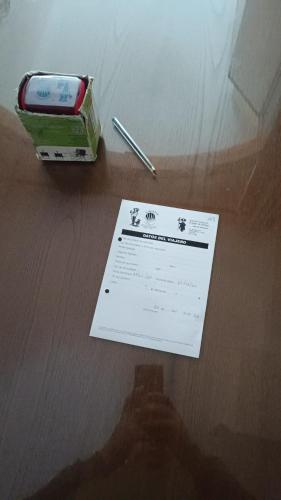 a pen and a piece of paper on a table at Albergue Ultreia Sigueiro in Sigüeiro