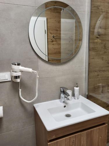 a bathroom with a sink and a mirror at Martinas Lake Front Apartment in Ohrid