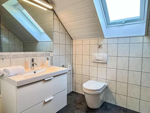 a bathroom with a sink and a toilet and a window at Apartment Land in Sicht by Interhome in Rulfingen