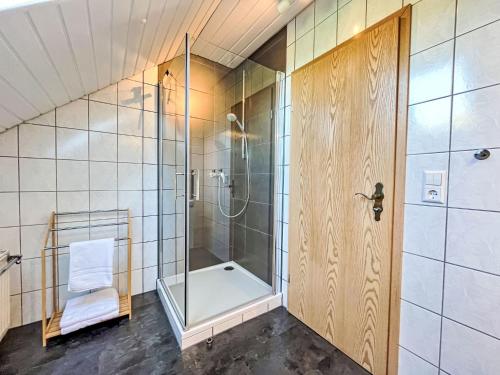 a bathroom with a shower and a glass door at Apartment Land in Sicht by Interhome in Rulfingen