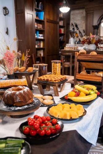 a table filled with different types of food on plates at Hotel Boutique Vila 8 in Durrës