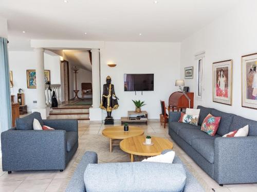 un salon avec deux canapés bleus et une table dans l'établissement Villa Cacharel by Interhome, à Sainte-Maxime