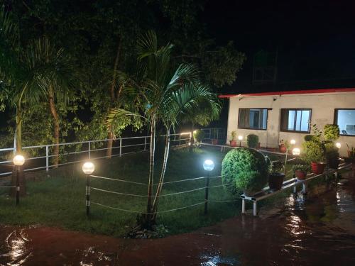 a house with lights in the yard at night at Ekantam Aspen By Yatri India Hospitality in Rishīkesh