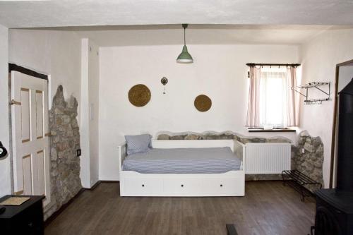 a bedroom with a white bed and a window at Penzion Albeř in Nová Bystřice