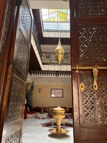 an open door to a room with a fountain in a building at Riad Golf Stinia 1 in Meknès