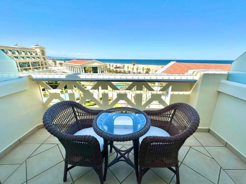 a table and chairs on a balcony with a view of the ocean at Las Arenas Balneario Resort in Valencia