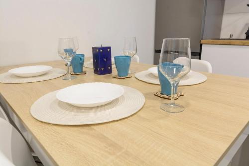 a table with plates and wine glasses on it at Laredo Suite 2 in Laredo