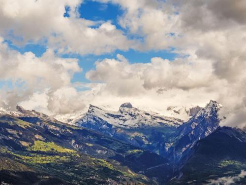 a snow covered mountain under a cloudy sky at Apartment Quille du diable 19 by Interhome in Nendaz