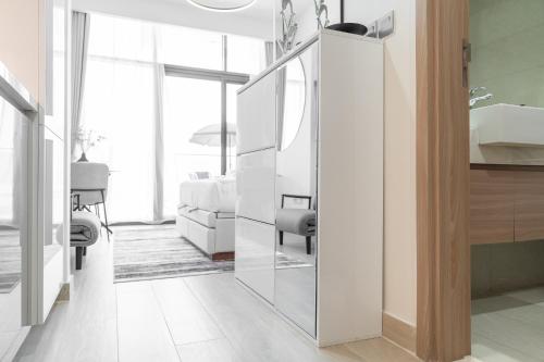 a bathroom with a mirror next to a bedroom at Chic and comfortable Studio Near Downtown and Canal in Dubai