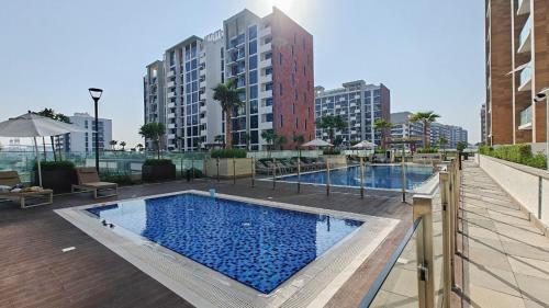 a large swimming pool on top of a building at Chic and comfortable Studio Near Downtown and Canal in Dubai
