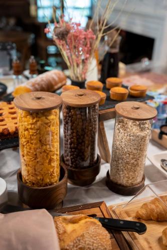 a table with four containers of food and bread at Hotel Boutique Vila 8 in Durrës