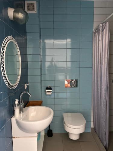 a bathroom with a sink and a toilet and a mirror at Lalala in Sopot