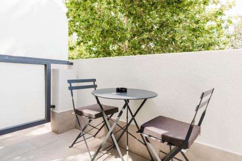 a small table and two chairs on a patio at Hotel Arena Select in Valencia