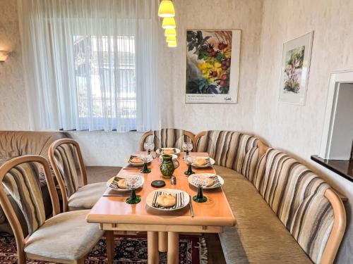a dining room with a wooden table and chairs at Holiday Home Uhu by Interhome in Dittishausen