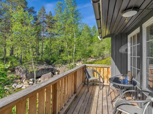 a deck with a table and chairs on a house at Holiday Home Berthabu by Interhome in Øyuvstad