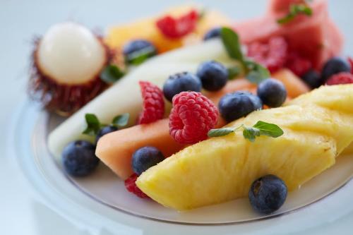 a plate of fruit on a white plate at Four Seasons Hotel New York in New York