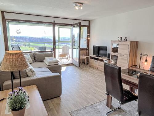 a living room with a couch and a table at Apartment Bergliebe - G 103 by Interhome in Dittishausen