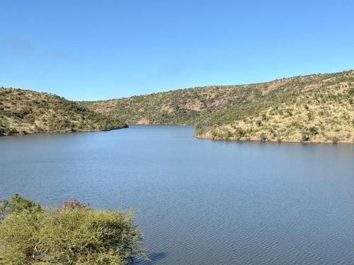 a large body of water with mountains in the background at Fish Eagle Manor in Warmbaths