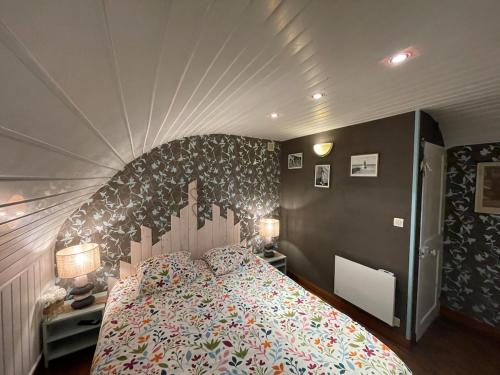 a bedroom with a large bed with a large headboard at Côte & Mer in Fécamp