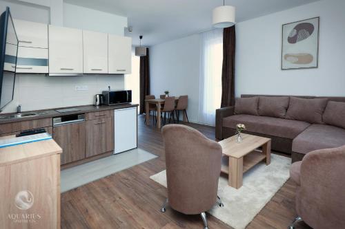 a living room with a couch and a table at Aquarius Apartments in Miskolctapolca