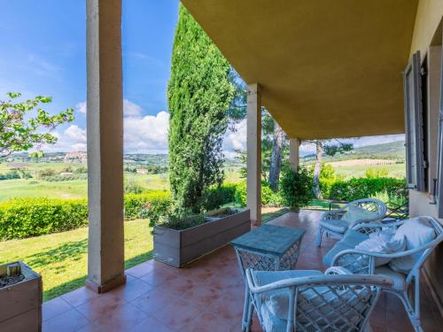 a patio with chairs and tables and a view at Holiday Home La Carraia by Interhome in Bibbona