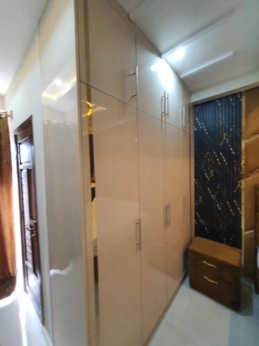 a bathroom with a glass shower with a bench in it at Pova Hotel Suits and Apartments in Rawalpindi